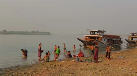 Local people taking bath and washing clothes in river, Burma Stock Footage 62923766