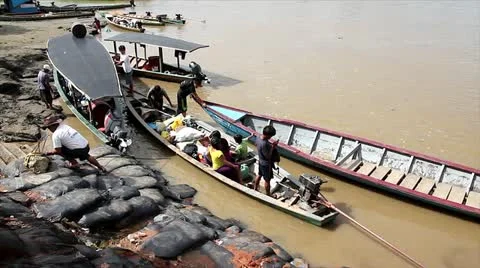 Local Peruvian people load up their boats before departing down river, ca. 2011 Stock Footage 10995522