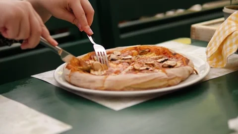 The local restaurant makes and cuts delicious pizza to perfection Stock Footage 283629196