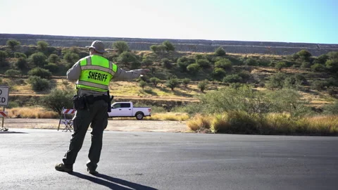 A local sheriff directing traffic at an event Stock Footage 221723167