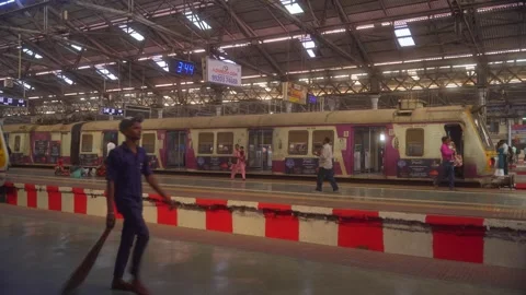 A local suburban train departure from platform, Vacant train on the adjacent Stock Footage 309293507