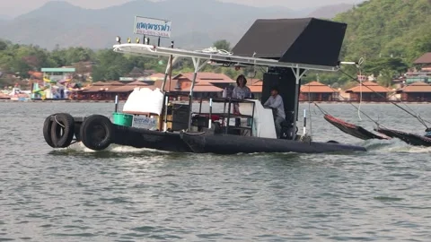 Local Thai tugboat towing floating house rafts Stock Footage 344157658