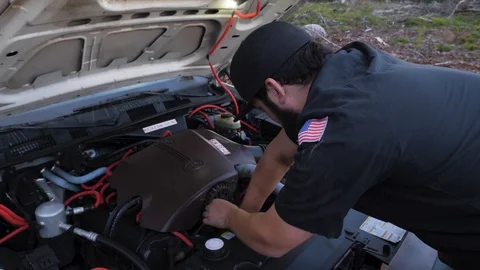Local town mechanic working hard on engine checking car Vídeo Stock 107612683