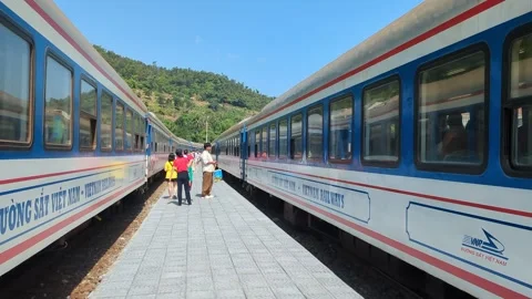 Local train arriving at Lang Co station Vietnam, Handheld 4k. Stock Footage 313486466
