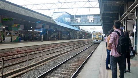  Local train arriving on a platform in Mumbai Stock Footage 127336380