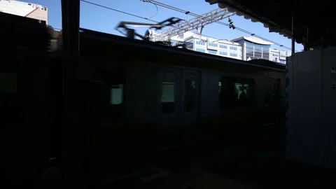 Local train comes in the railway station at sunny day. Tokyo Japan. Stock Footage 220095674