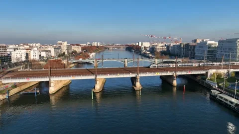 Local train crossing the river Seine aerial shot in Paris France pollution blue  Stock Footage 250357434