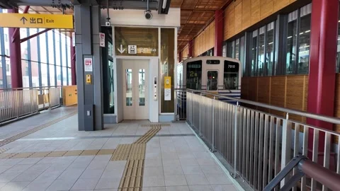 Local train at Fukui Station platform with elevator access on the Eiheiji Line Stock Footage 309949712
