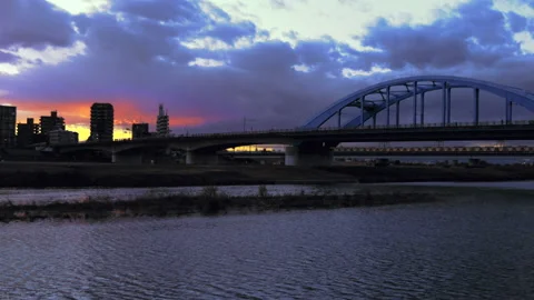 Local Train passing on a bridge during twilight Stock-Footage 228662933