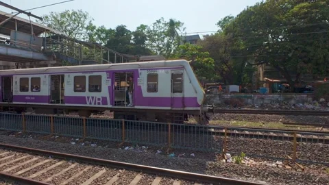 Local train passing by, Mumbai, India. Real time motion video. Stock Footage 313532877