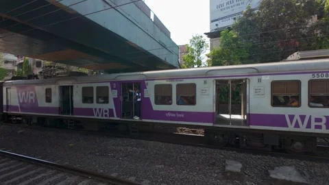 Local train passing by, Mumbai, India. Real time motion video. Stock Footage 313532918