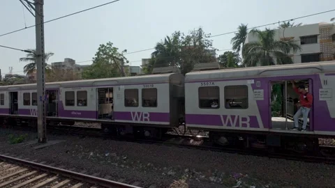 Local train passing by, Mumbai, India. Real time motion video. Stock Footage 313532944