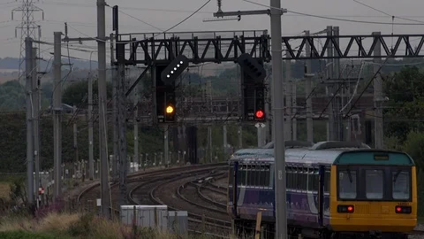 Local train stopping at lights on a track in England 4K Stock-Footage 92602623