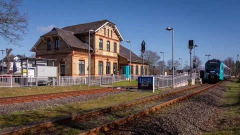 A local train stopping at a station in Germany Stock Footage 337891750