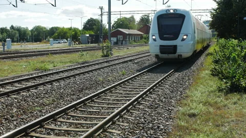 A local train in Sweden arriving to a train station Vídeo Stock 229729862
