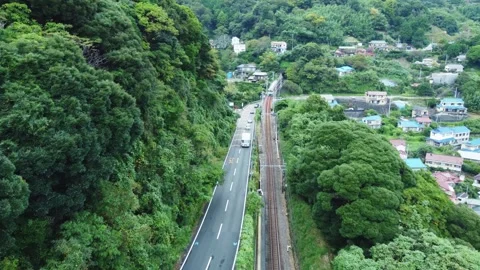 Local Train Tracks Through Mountain Countryside on Cloudy Day Stock Footage 290342893