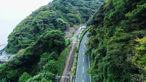 Local Train Tracks Through Mountain Countryside on Cloudy Day Stock Footage 290342944