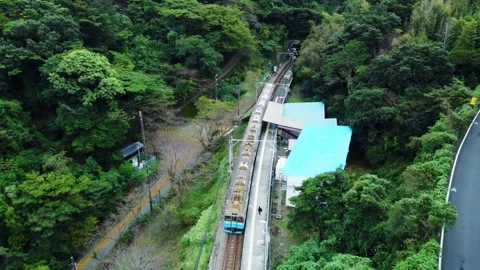 Local Train Tracks Through Mountain Countryside on Cloudy Day Stock Footage 290343099