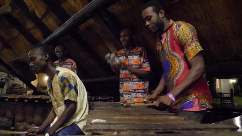 Local tribe play on drums and marimba near Victoria Falls waterfall in Zimbabwe Stock Footage 254348666
