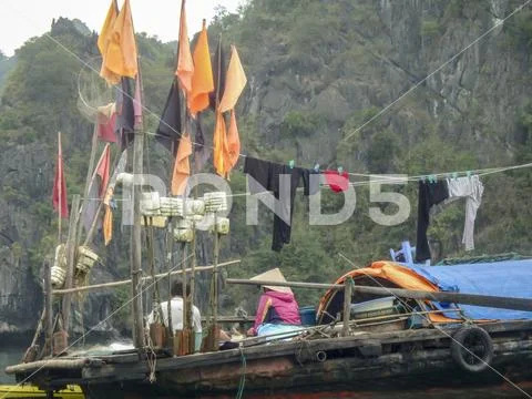 Local villagers on fishing boats in Ha Long Bay Vietnam Stock Photos
