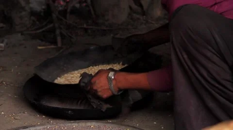 Local woman using a sieve to separate sand from the food grain, Mustang, Nepal Stock Footage 62923998