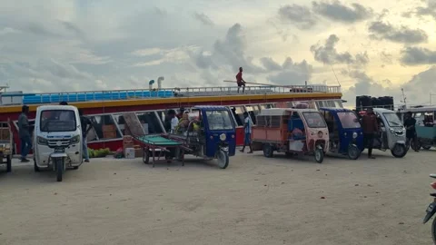 Local workers transport construction materials on Maafushi, Maldives, to Stock Footage 327303737