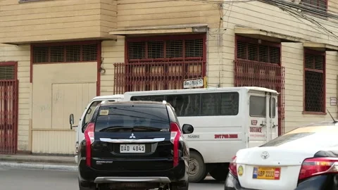 Locals cross a busy intersection in a small city in the Philippines Stock Footage 201302884