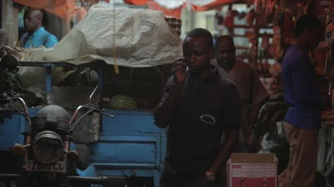 Locals drop off supplies and do business at the Zanzibar spice market. Stock Footage 86648317