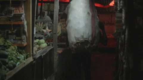 Locals drop off supplies and do business at the Zanzibar spice market. Stock Footage 86648367