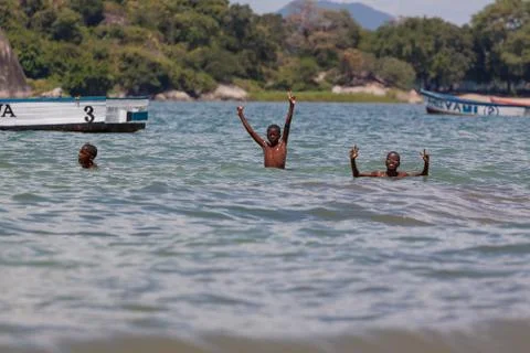 Locals enjoying the great beaches of the large inland lake, Lake Malawi. Stock Photos