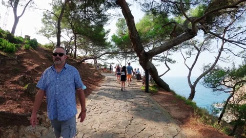 Locals rest on top of a cliff in Tossa de Mar Stock Footage 172064272