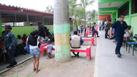 Locals wait to be seen by doctors and medical team at medical center in Ecuador Video stock 97634857
