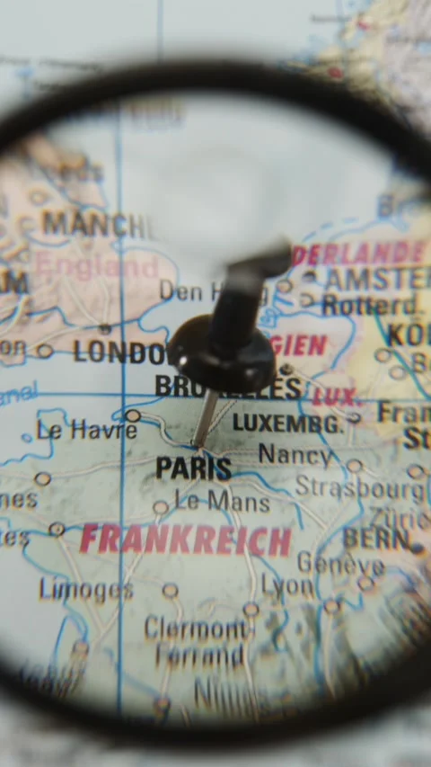 Location of Paris highlighted on a map viewed through a magnifying glass Stock-Footage 343289036