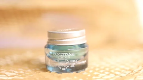 A Loccitane moisturizing cream on the table Stock Footage 154010368