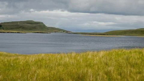 Loch leathan at the Isle of Skye with a dramatic cloudly sky in background Stock Photos