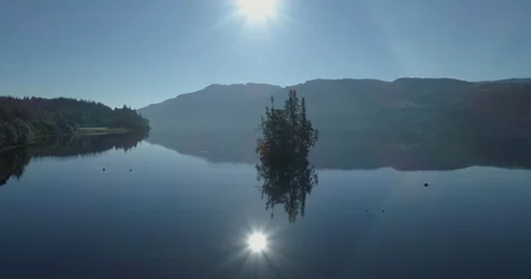 Loch Ness - aerial pullback along the surface of the water revealing fishing 動画素材 112004441