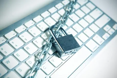 Lock and chain on a keyboard. Internet security concept. Toned. Stock Photos