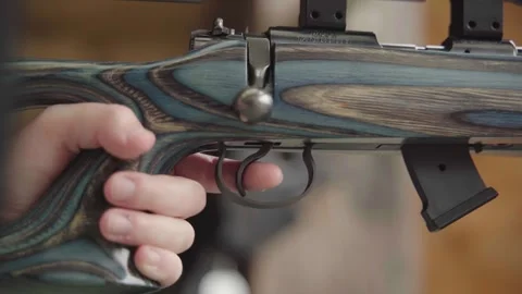 Lock and loading the chamber of rifle ready to pull the trigger. Handheld Video stock 257586103