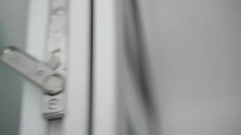 A lock blocking an additional leaf of a double door, close-up. Hand opens and Stock Footage 240601240