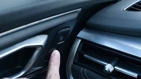 Lock button for unlocking the vehicle door release. Person presses the car .. Stock Footage 287297085