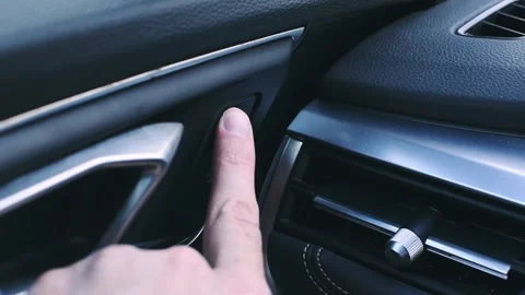 Lock button for unlocking the vehicle door release. Person presses the unlo.. Stock Footage 287297092