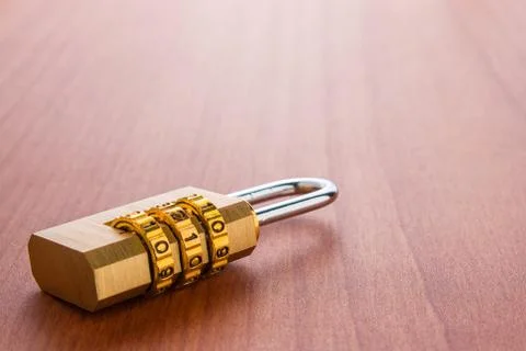 Lock with the code set on the wooden background. Stock Photos