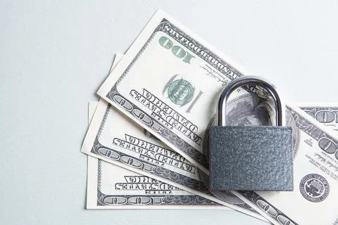 Lock on dollar bills Stock Photos
