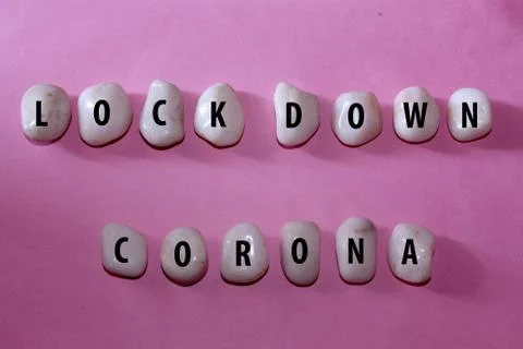 Lock down corona text on white rock Stock Photos