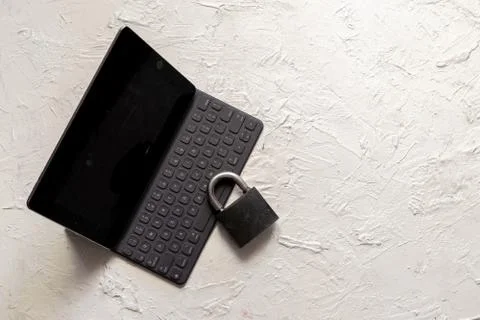 A lock with a gadget, network and personal data security concepts Foto stock