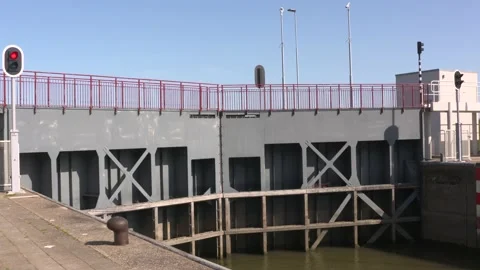 A lock gate is opened to allow a boat to enter the lock chamber Stock Footage 139607798