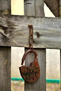 The lock on the gate in the village. Stock Photos