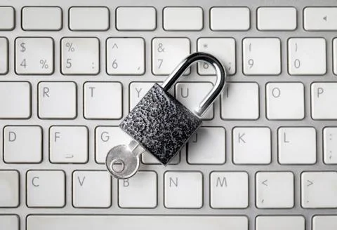 Lock with key on computer keyboard Stock Photos