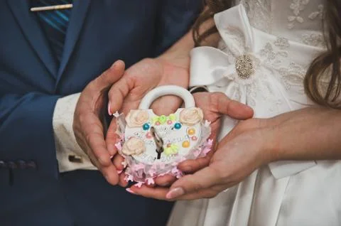 The lock with a key in hands of the newly-married couple 2168. Stock Photos