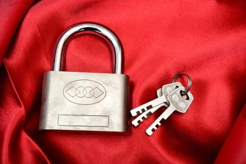 Lock with Keys isolated on red silk background Stock Photos